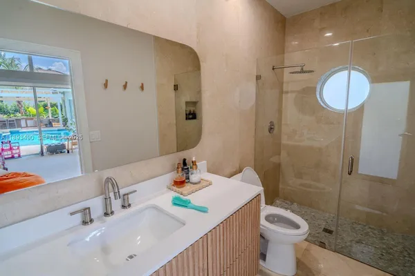 a bathroom with a sink a toilet and shower