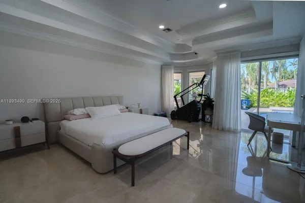 a bedroom with a bed and large windows