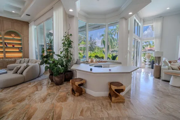 a living room with furniture and potted plant