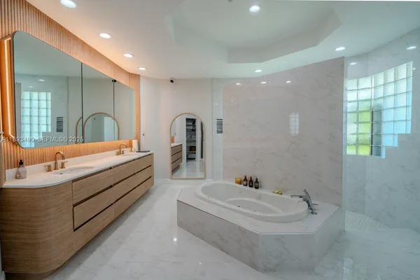 a bathroom with a double vanity sink and a bathtub