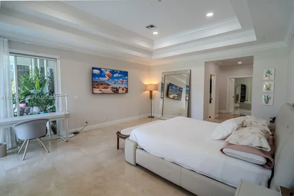 a spacious bedroom with a bed and a table