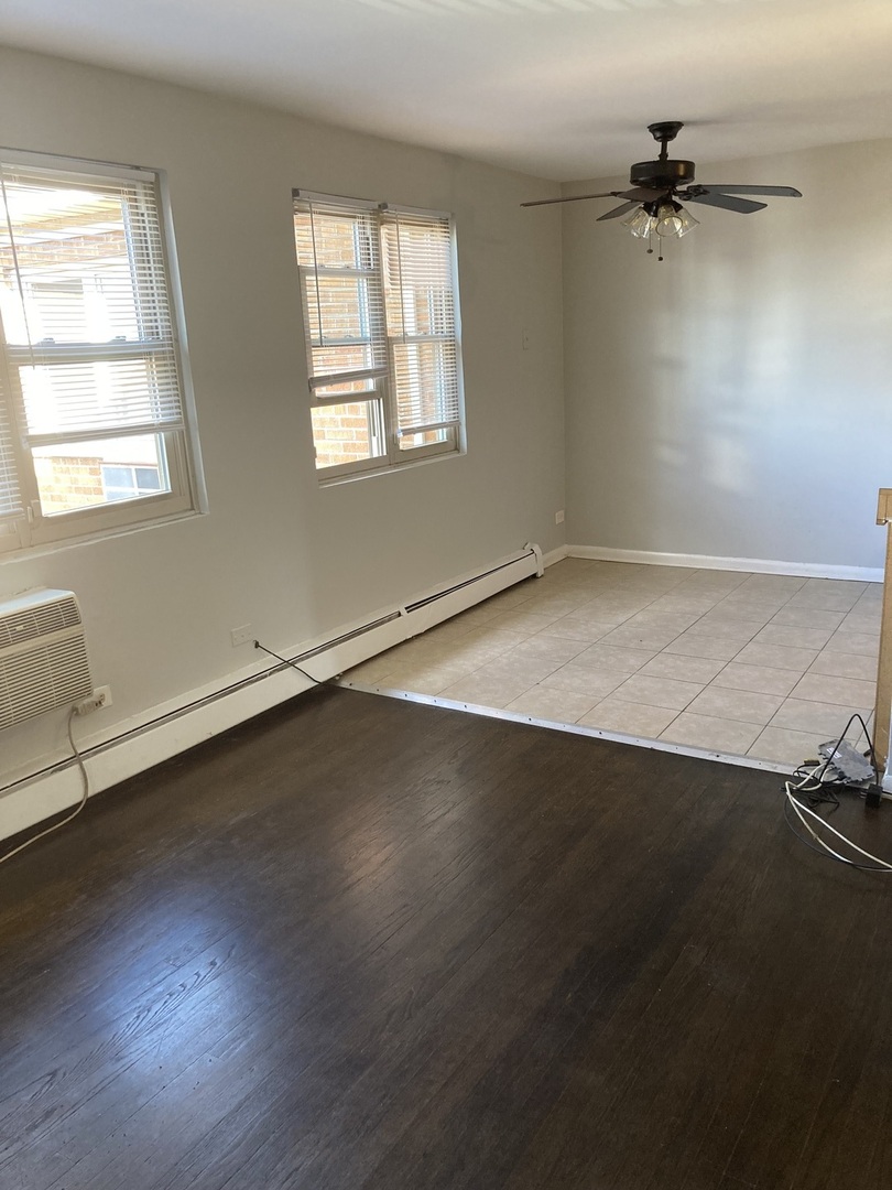2420 West Berwyn Avenue, Unit 304 Chicago, IL 60625 - Photo 3 of 9 wooden floor in an empty room with a window