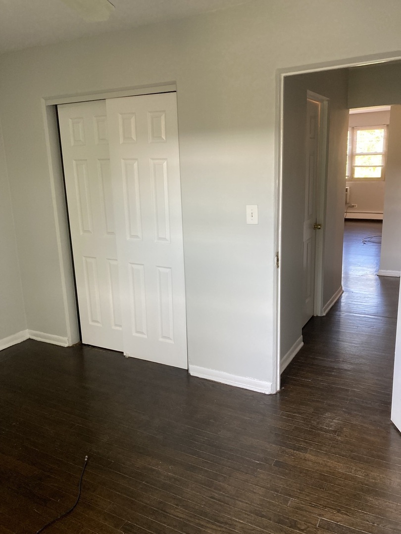 2420 West Berwyn Avenue, Unit 304 Chicago, IL 60625 - Photo 5 of 9 an empty room with wooden floor and closet