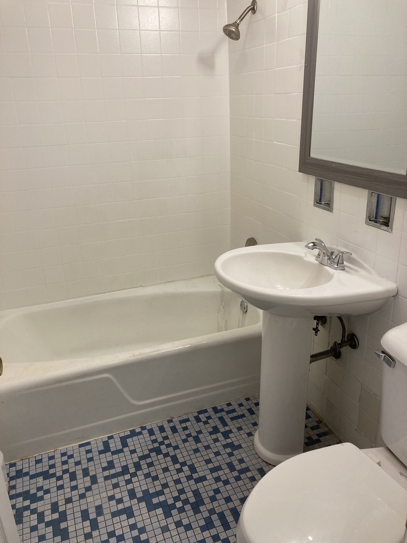 2420 West Berwyn Avenue, Unit 304 Chicago, IL 60625 - Photo 9 of 9 a bathroom with a sink toilet and shower