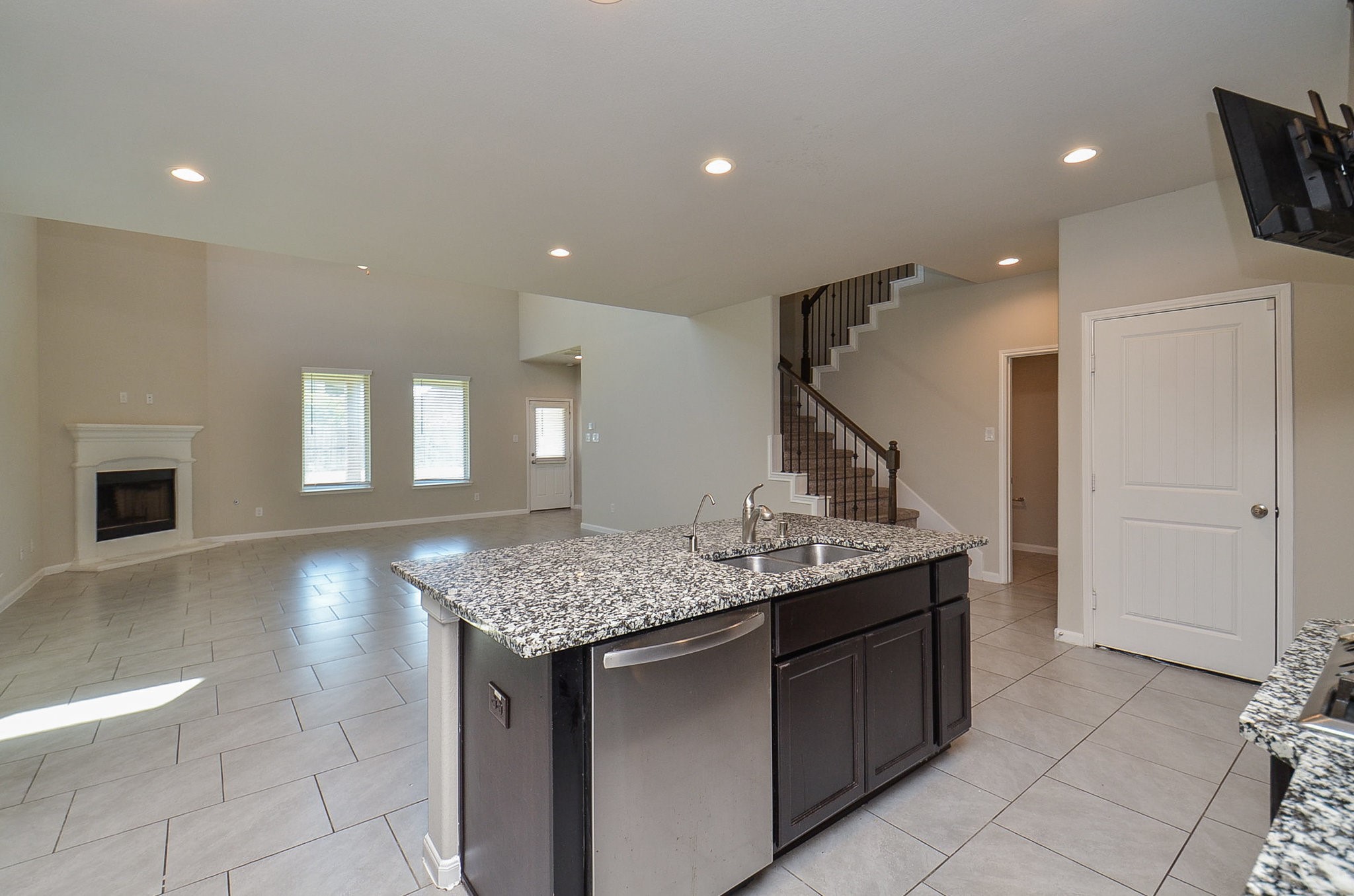 a kitchen with a sink a counter space and wooden floor