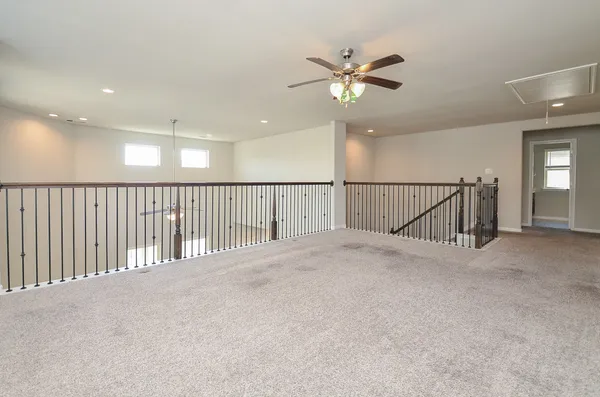 a view of a hallway with a ceiling fan