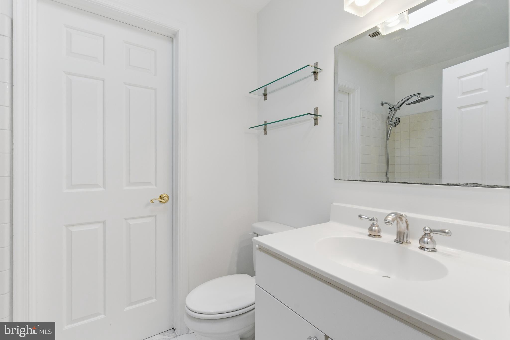 1203 N Street Northwest, Unit E Washington, DC 20005 - Photo 21 of 24 a bathroom with a sink a toilet and shower