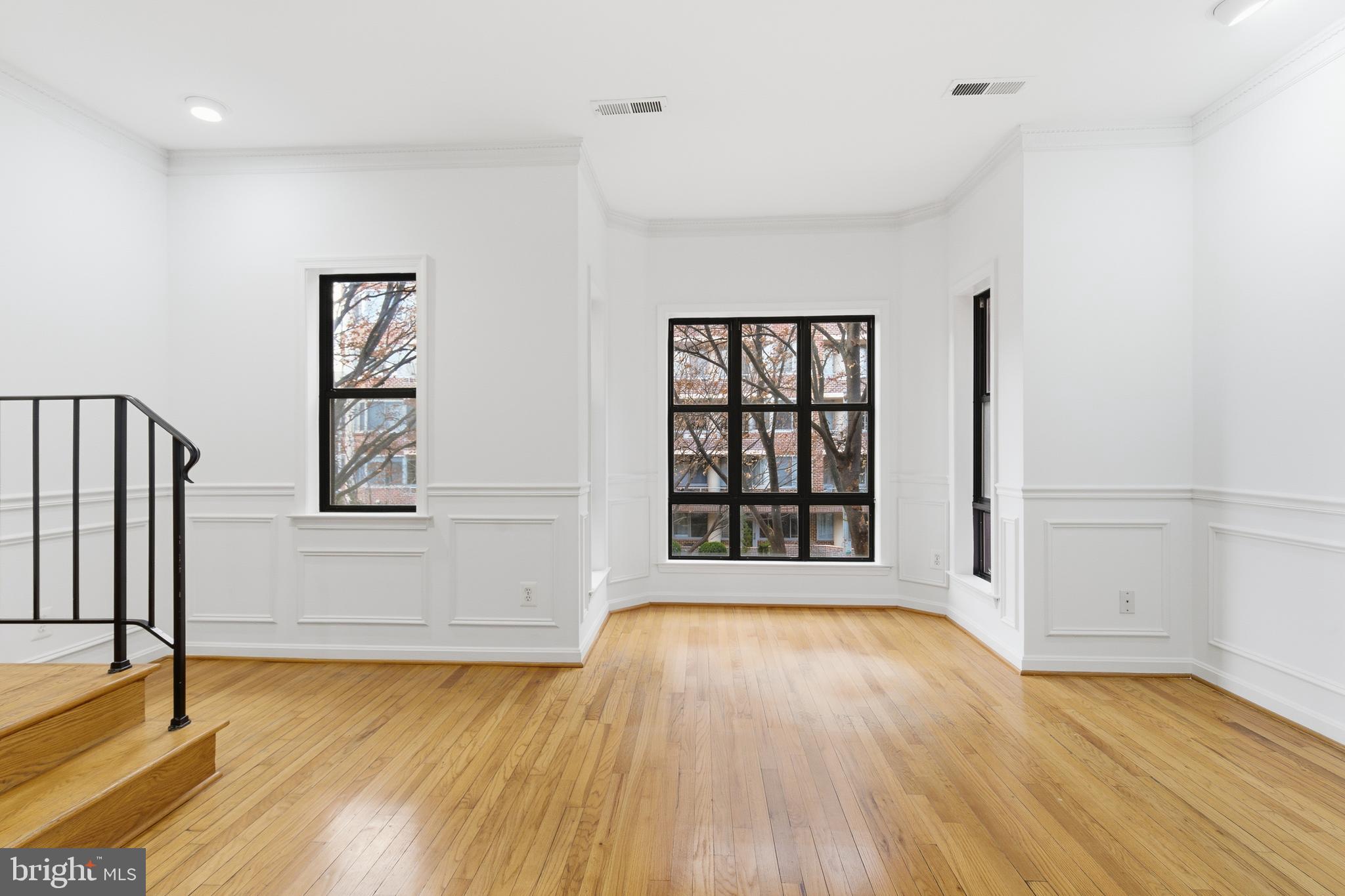 1203 N Street Northwest, Unit E Washington, DC 20005 - Photo 3 of 24 a view of an empty room with wooden floor and a window