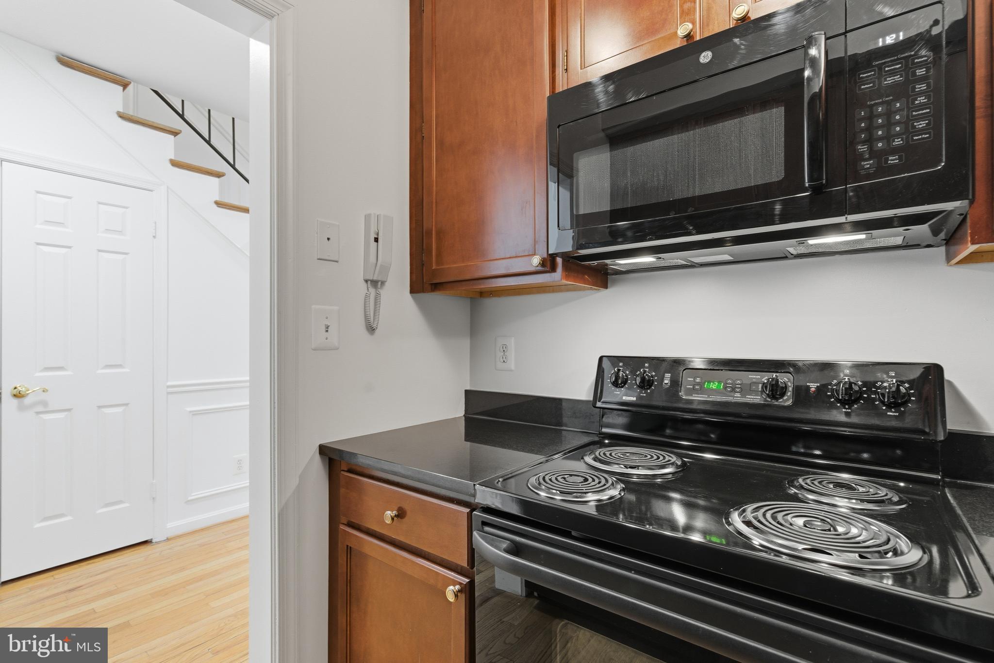 1203 N Street Northwest, Unit E Washington, DC 20005 - Photo 9 of 24 a stove top oven sitting inside of a kitchen