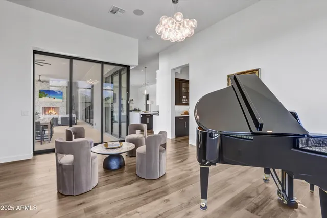 a living room with furniture a window and a chandelier