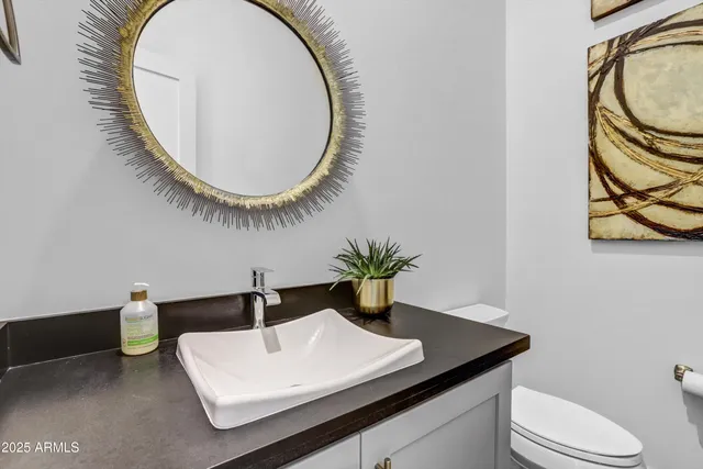 a bathroom with a sink a mirror and a toilet