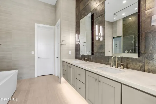 a bathroom with a double vanity sink mirror and double