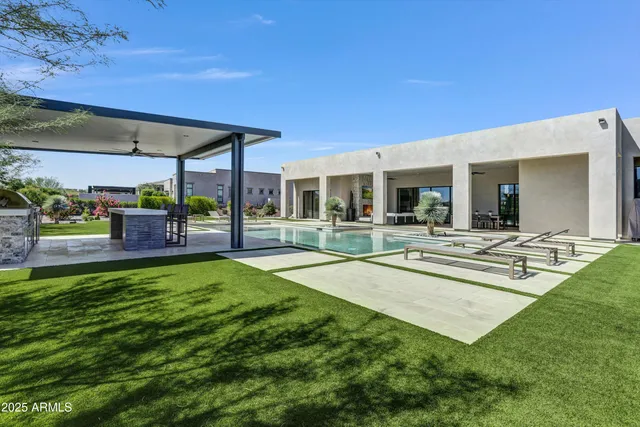 a swimming pool with outdoor seating and yard