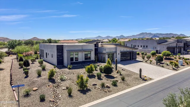 an aerial view of residential houses with outdoor space and seating