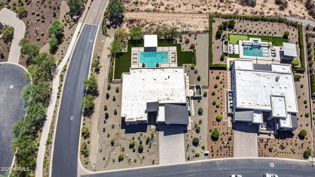 an aerial view of a house with garden space and sitting area