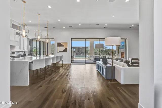 a large kitchen with lots of counter top space a sink stainless steel appliances and cabinets