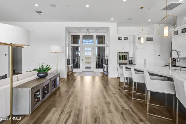 a kitchen with stainless steel appliances a refrigerator and a stove top oven