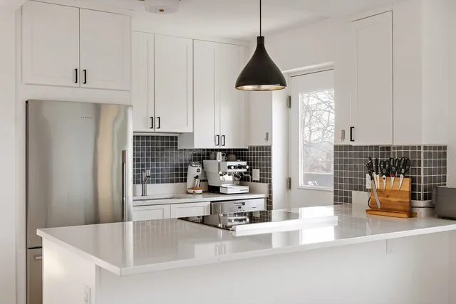 a kitchen with stainless steel appliances kitchen island granite countertop a sink and cabinets