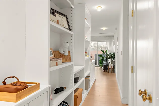 a hallway with a view of living room