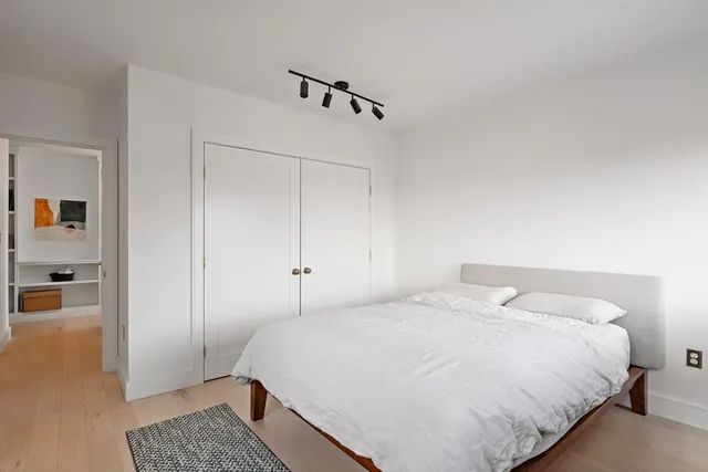 a bedroom with a bed and a table