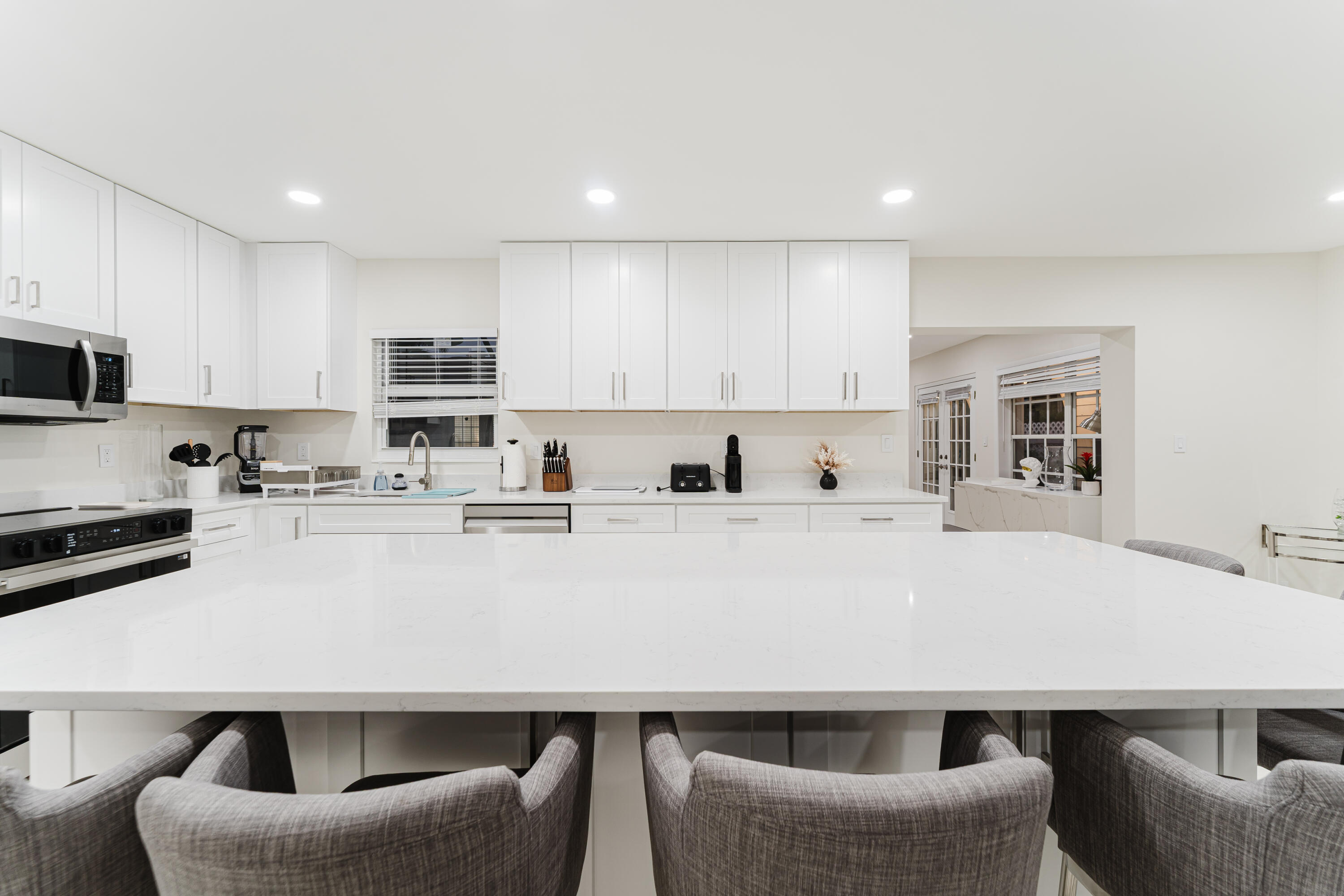 3199 Northeast 6th Drive Boca Raton, FL 33431 - Photo 20 of 49 a kitchen with a table chairs sink and microwave