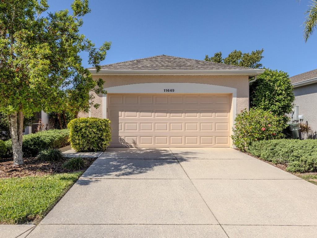 11649 Tempest Harbor Loop Venice, FL 34292 - Photo 1 of 39 a front view of a house with a yard and garage