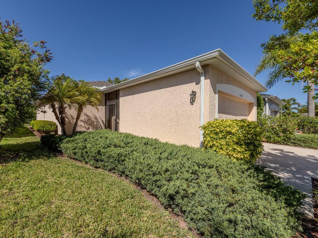 11649 Tempest Harbor Loop Venice, FL 34292 - Photo 2 of 39 a front view of a house with garden
