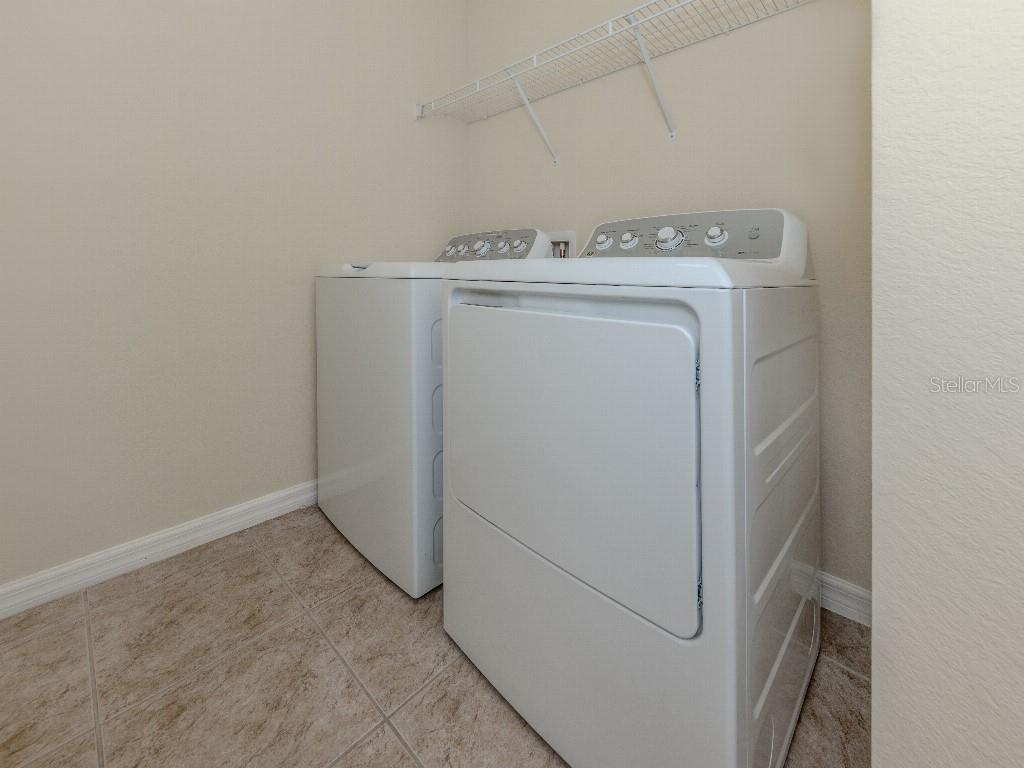 11649 Tempest Harbor Loop Venice, FL 34292 - Photo 22 of 39 a utility room with dryer and washer