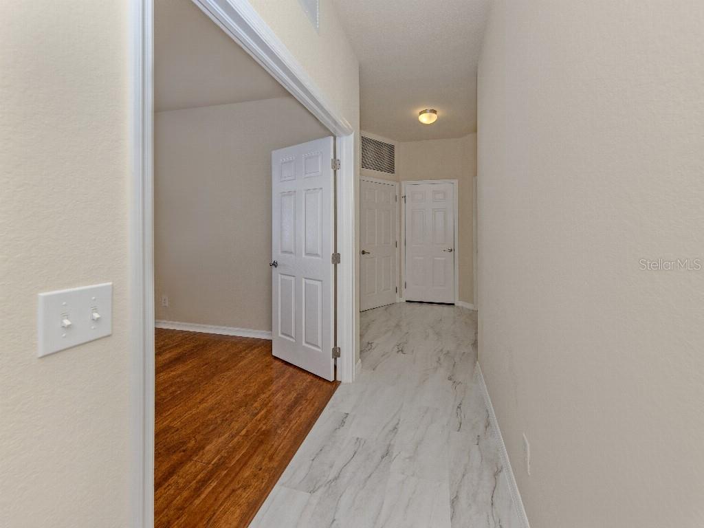 11649 Tempest Harbor Loop Venice, FL 34292 - Photo 4 of 39 a view of a hallway with wooden floor