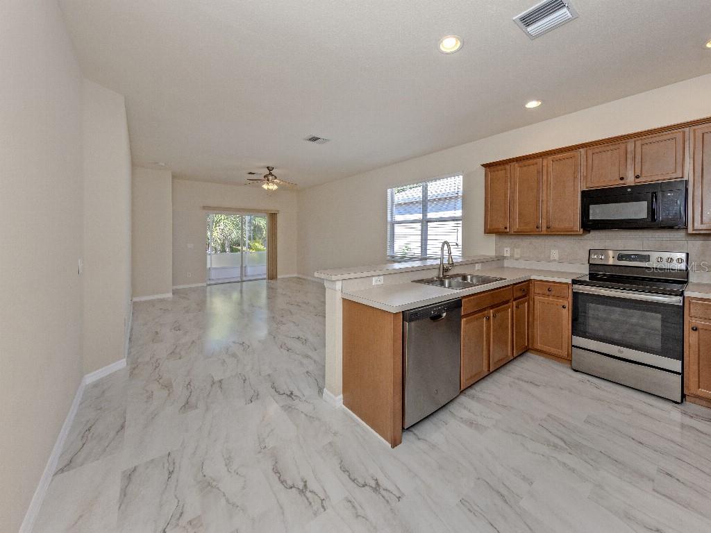 11649 Tempest Harbor Loop Venice, FL 34292 - Photo 7 of 39 a kitchen with a sink and steel appliances