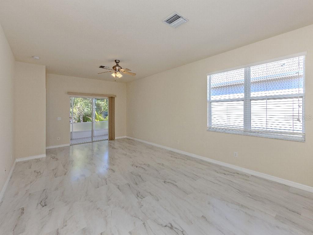 11649 Tempest Harbor Loop Venice, FL 34292 - Photo 10 of 39 wooden floor in an empty room with a window