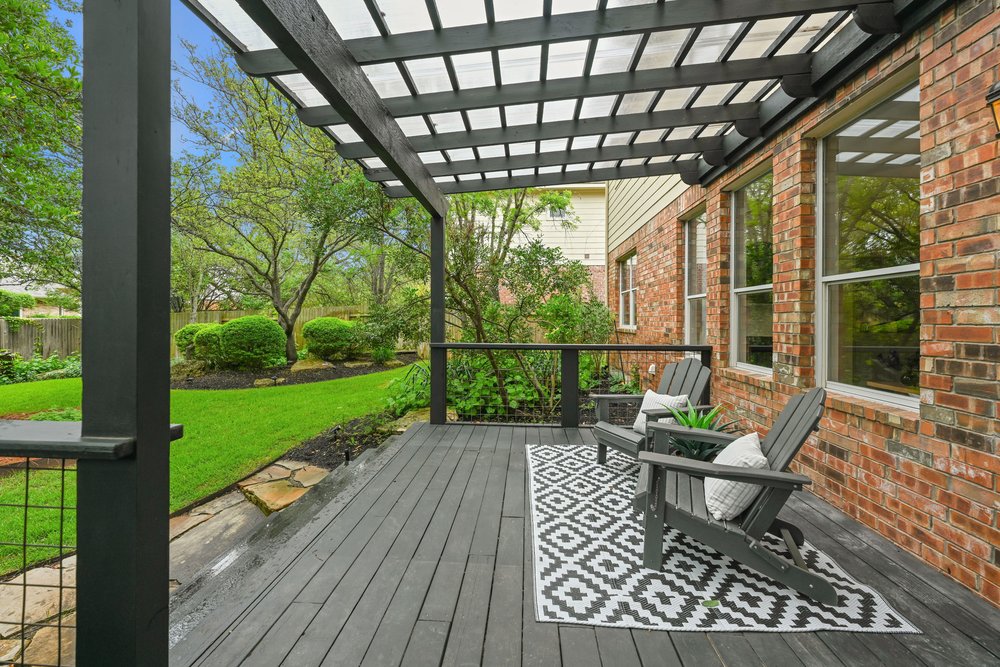 2823 Lantana Ridge Drive Austin, TX 78732 - Photo 28 of 34 a view of a porch with wooden floor chairs and a table