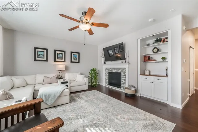 a living room with furniture fireplace and flat screen tv