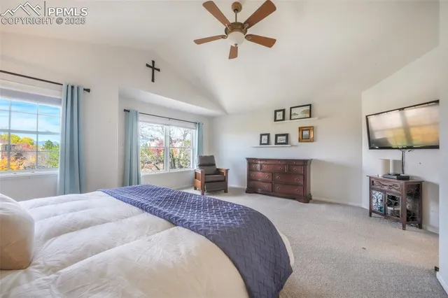 a spacious bedroom with a bed and a couch