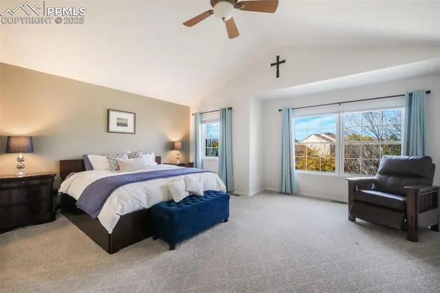 a spacious bedroom with a bed and a television in it