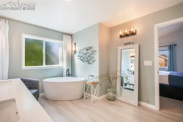 a spacious bathroom with a glass shower door a sink and a mirror