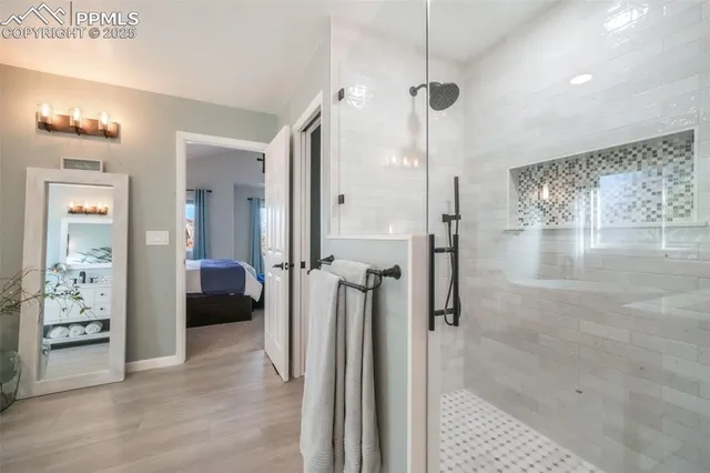 a view of walk in closet with clothes and shoes