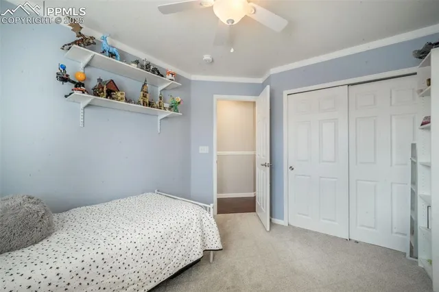 a bedroom with a bed and large windows