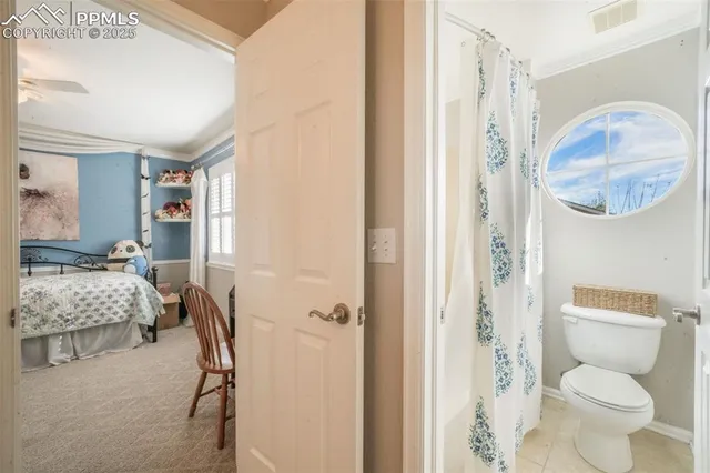 a bedroom with a bed chair and a window