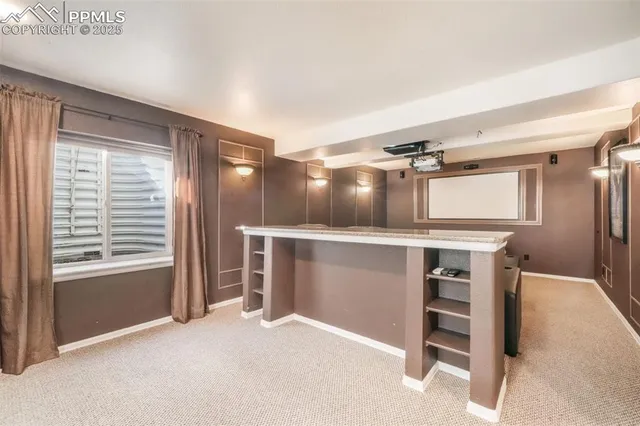 a living room with furniture and a glass door