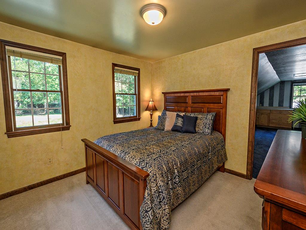 1671 Coulter Road Apollo, PA 15613 - Photo 23 of 25 Second Bedroom - Very nice size with a double closet and to the right you can see a bit of the huge bonus room that has built-in storage counters and tons of eave storage. Great for hobbyist, gym, studio, or other!