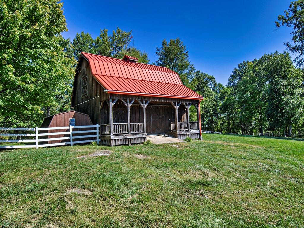 1671 Coulter Road Apollo, PA 15613 - Photo 6 of 25 The beautiful wood barn has a red metal roof and offers three stalls, storage and a covered area/doors that face out to one of three fenced in paddocks.
