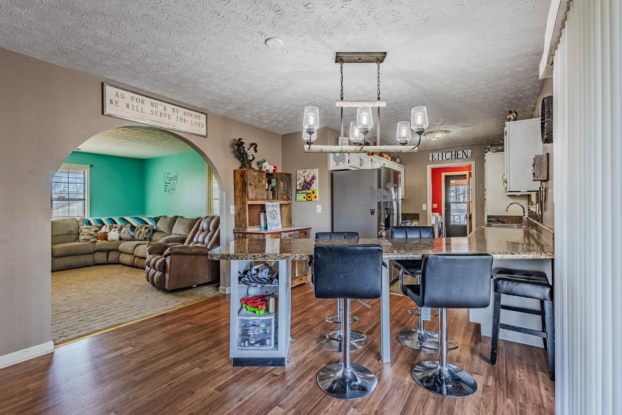 947 Butler Road Niota, TN 37826 - Photo 7 of 43 a view of a dining room with furniture a chandelier and wooden floor