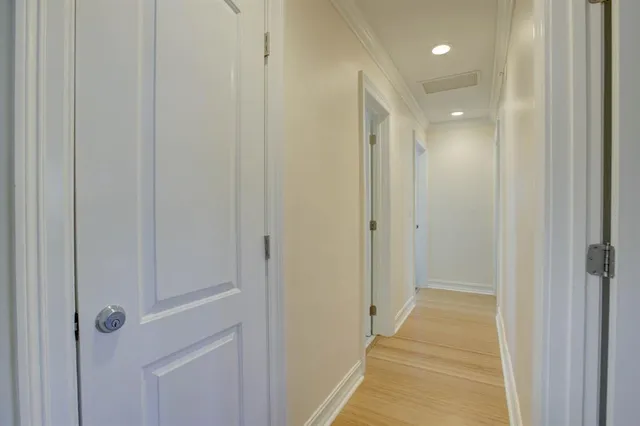a view of a hallway with a wooden door