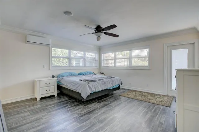 a bedroom with a bed and a ceiling fan