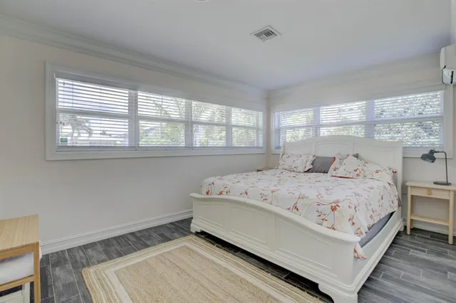 a bedroom with a bed and window