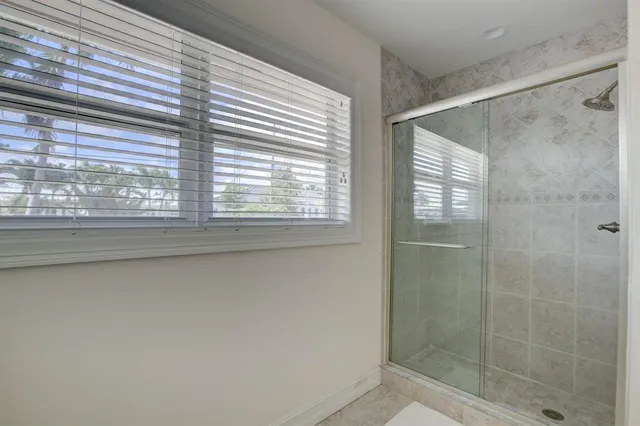 a bathroom with a shower and a window
