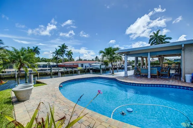 a view of a swimming pool with outdoor seating