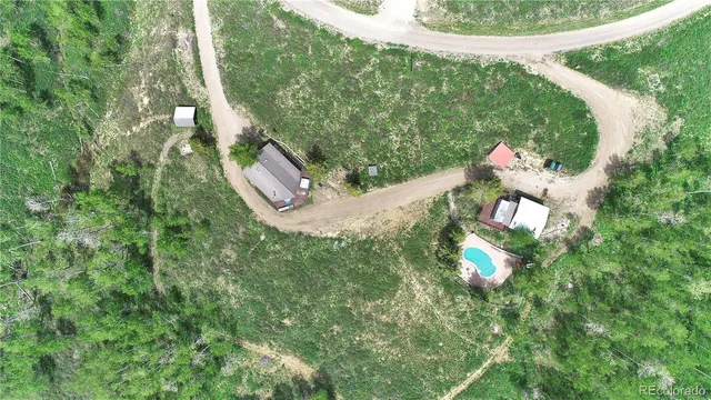 a living room with furniture a flat screen tv and a floor to ceiling window