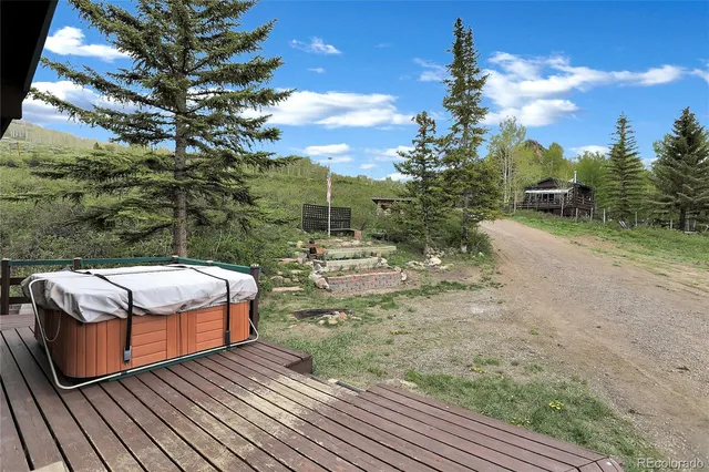 a view of a wooden chairs and table in the patio